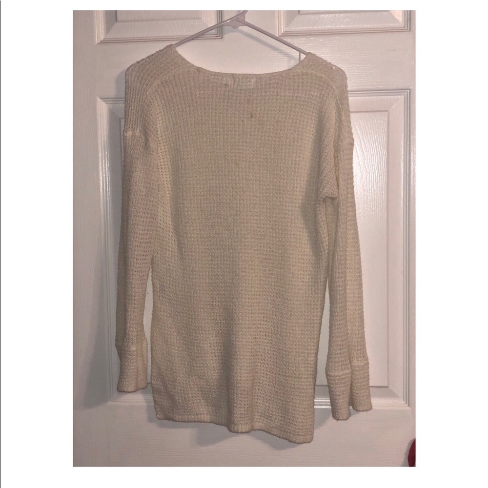 A cream colored sheer sweater. Never worn before.